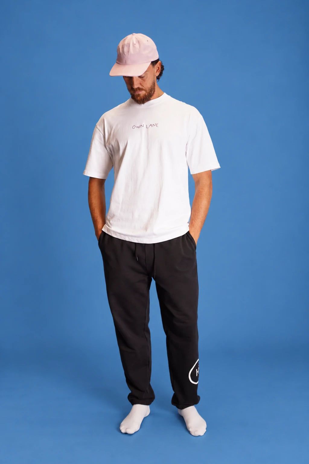 studio front view of the men’s white Own Lane T-shirt